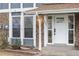 Charming front door with brick accents and clearly displayed house number at 12054 E 3Rd Ave, Aurora, CO 80011