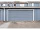Exterior view of garage with blue door and white trim at 12054 E 3Rd Ave, Aurora, CO 80011