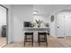 Kitchen view with barstool seating at the counter, a mosaic backsplash, and an adjacent laundry closet at 12054 E 3Rd Ave, Aurora, CO 80011