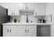 Well-lit kitchen boasts bright cabinetry, modern appliances, and clean countertops at 12054 E 3Rd Ave, Aurora, CO 80011