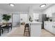 Bright kitchen area featuring a counter with bar stools, stainless steel appliances, and an open layout at 12054 E 3Rd Ave, Aurora, CO 80011