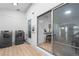 Bright laundry room with modern washer and dryer, adjacent to a stylish interior at 12054 E 3Rd Ave, Aurora, CO 80011