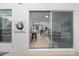 View of a cozy living area through sliding glass doors with bar seating and open staircase at 12054 E 3Rd Ave, Aurora, CO 80011