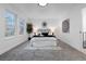Airy main bedroom featuring large windows, neutral decor, and a decorative light fixture above the bed at 12054 E 3Rd Ave, Aurora, CO 80011