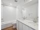 Bathroom features a double sink vanity with granite countertop, bathtub, and shower at 9081 Telluride Ct, Commerce City, CO 80022
