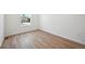Clean, bright bedroom with hardwood floors, white walls, and a window providing natural light at 9081 Telluride Ct, Commerce City, CO 80022