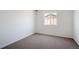 Carpeted bedroom with a large window at 9081 Telluride Ct, Commerce City, CO 80022