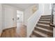 Bright foyer with hardwood floors, a staircase leading upstairs, and a view into the living area at 9081 Telluride Ct, Commerce City, CO 80022