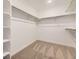 Walk-in closet with shelving and carpeting at 662 N Clubview St, Watkins, CO 80137