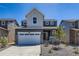Charming two-story home featuring a stone-accented garage and a welcoming front porch in a modern neighborhood at 662 N Clubview St, Watkins, CO 80137
