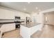 Bright kitchen featuring an island, stainless steel appliances, white cabinetry, and wood-style flooring at 662 N Clubview St, Watkins, CO 80137