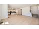 Open-concept living space featuring wood-style floors, a staircase, and a seamless transition to the kitchen at 662 N Clubview St, Watkins, CO 80137
