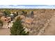 Aerial view of homes in a neighborhood with tree-lined streets and well-maintained yards; showcasing the real estate at 1571 S Trenton Ct, Denver, CO 80231
