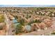 Overhead view capturing homes near tennis courts and a community pool, highlighting recreational amenities at 1571 S Trenton Ct, Denver, CO 80231