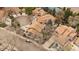 Aerial view of homes with brown roofs, tree-lined streets, and well-kept lawns in a suburban neighborhood at 1571 S Trenton Ct, Denver, CO 80231