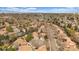 Aerial view capturing a community with residential homes, tennis courts, and a backdrop of mountains in the distance at 1571 S Trenton Ct, Denver, CO 80231