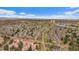 Scenic aerial view showcasing the community homes with tree-lined streets, distant mountains, and vibrant cityscape at 1571 S Trenton Ct, Denver, CO 80231