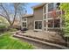 Cozy backyard with patio, mature landscaping, and privacy, ideal for outdoor gatherings at 1571 S Trenton Ct, Denver, CO 80231