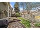 Spacious backyard with patio, lush lawn, and a wooden fence, perfect for Gathering fun and relaxation at 1571 S Trenton Ct, Denver, CO 80231