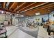 Unfinished basement offers potential for customization with exposed beams, shelving and laundry hookups at 1571 S Trenton Ct, Denver, CO 80231