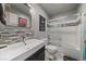 Clean, modern bathroom features a tiled shower/tub and sleek vanity at 1571 S Trenton Ct, Denver, CO 80231