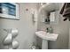 Elegant half-bathroom with modern sink, stylish mirror, and gray color palette at 1571 S Trenton Ct, Denver, CO 80231