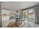 Stylish dining area with modern chandelier, glass table, and sliding doors to the backyard at 1571 S Trenton Ct, Denver, CO 80231