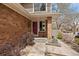 Close up of front door and entry showcasing brickwork and landscaped walkway at 1571 S Trenton Ct, Denver, CO 80231