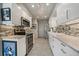 Contemporary kitchen featuring white cabinets, granite countertops, and stainless steel appliances at 1571 S Trenton Ct, Denver, CO 80231