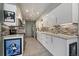 Bright, modern kitchen with white cabinets, stainless steel appliances, and stylish backsplash at 1571 S Trenton Ct, Denver, CO 80231