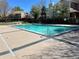 Community outdoor swimming pool with clear blue water and well-maintained concrete surround on a bright day at 1571 S Trenton Ct, Denver, CO 80231