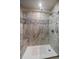 Tiled shower with a glass door, bench, and chrome fixtures for a spa-like experience at 1571 S Trenton Ct, Denver, CO 80231