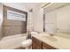 Clean basement bathroom with tub, shower, and wood vanity at 2457 S Xenon Way, Denver, CO 80228