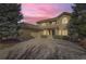 Two-story home with a large driveway and beautiful sunset at 2457 S Xenon Way, Denver, CO 80228