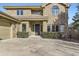 Front view of a two-story brick home with a landscaped yard at 2457 S Xenon Way, Denver, CO 80228