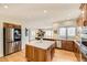 Spacious kitchen featuring island, stainless steel appliances, and hardwood floors at 2457 S Xenon Way, Denver, CO 80228