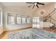 Bright living room with hardwood floors, vaulted ceilings, and a view of the backyard at 2457 S Xenon Way, Denver, CO 80228