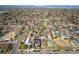 An aerial view presents a dense residential neighborhood with mature trees and distant mountain views at 2921 Newton St, Denver, CO 80211