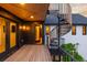 This balcony includes a black spiral staircase, wood-look decking, and modern outdoor lighting at 2921 Newton St, Denver, CO 80211