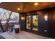 A covered balcony features black siding and a wood-look deck with double doors leading inside at 2921 Newton St, Denver, CO 80211
