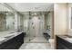 Bright bathroom with dual shower heads, glass door, vanity with marble countertop, and toilet at 2921 Newton St, Denver, CO 80211