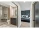 Modern bathroom with a walk-in shower, sleek vanity, and adjacent bedroom at 2921 Newton St, Denver, CO 80211