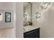 Modern bathroom features a stylish sink, mirror, and unique bubble lights that add a touch of contemporary elegance at 2921 Newton St, Denver, CO 80211