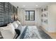 Bedroom featuring window and accent wall with bedside tables and white bedding at 2921 Newton St, Denver, CO 80211