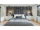 Modern bedroom featuring accent wall, white nightstands, and a large bed with stylish gray bedding at 2921 Newton St, Denver, CO 80211