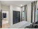 Cozy bedroom boasts comfortable bed, modern curtains, and an adjacent hallway for easy access to other rooms at 2921 Newton St, Denver, CO 80211