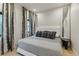 Serene bedroom with a comfortable bed, stylish curtains, and minimalist decor for a relaxing retreat at 2921 Newton St, Denver, CO 80211