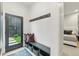 Inviting entryway with stylish bench, hooks, and a view into the bedroom, perfect for welcoming guests and relaxing at 2921 Newton St, Denver, CO 80211