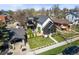 An exterior view reveals an upscale home with sophisticated design elements and a verdant front lawn at 2921 Newton St, Denver, CO 80211
