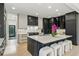 Spacious kitchen with modern cabinets, marble counters, a kitchen island with seating, and stainless steel appliances at 2921 Newton St, Denver, CO 80211